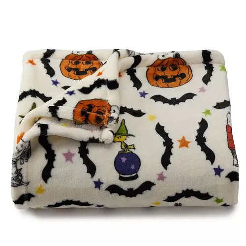A white fleece blanket featuring Halloween-themed designs such as pumpkins, bats, and stars, with a soft and cozy texture.