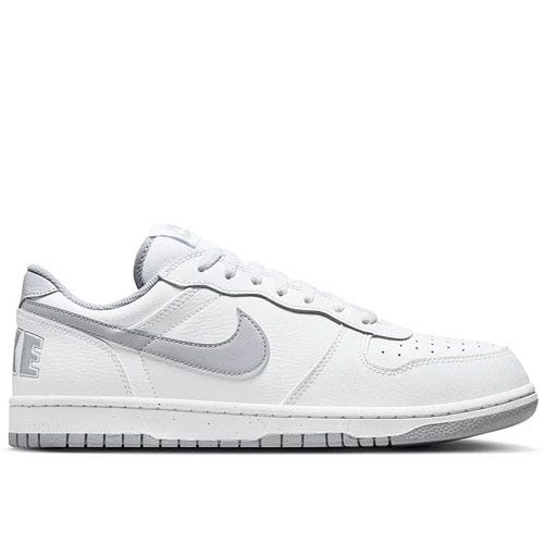 White and gray low-top sneaker with a large \“Nike\“ logo on the heel and a swoosh on the side.