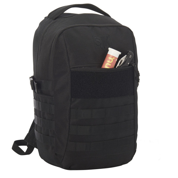 A black tactical backpack with MOLLE webbing features a front pocket containing a small cylindrical container and a folding knife.