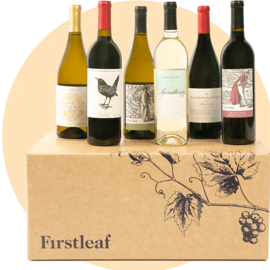 A box from Firstleaf containing six bottles of wine, each with distinct labels and designs, displayed neatly in front of the box.
