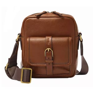 Brown leather crossbody bag with front pocket, buckle detail, and adjustable strap featuring brass hardware accents.