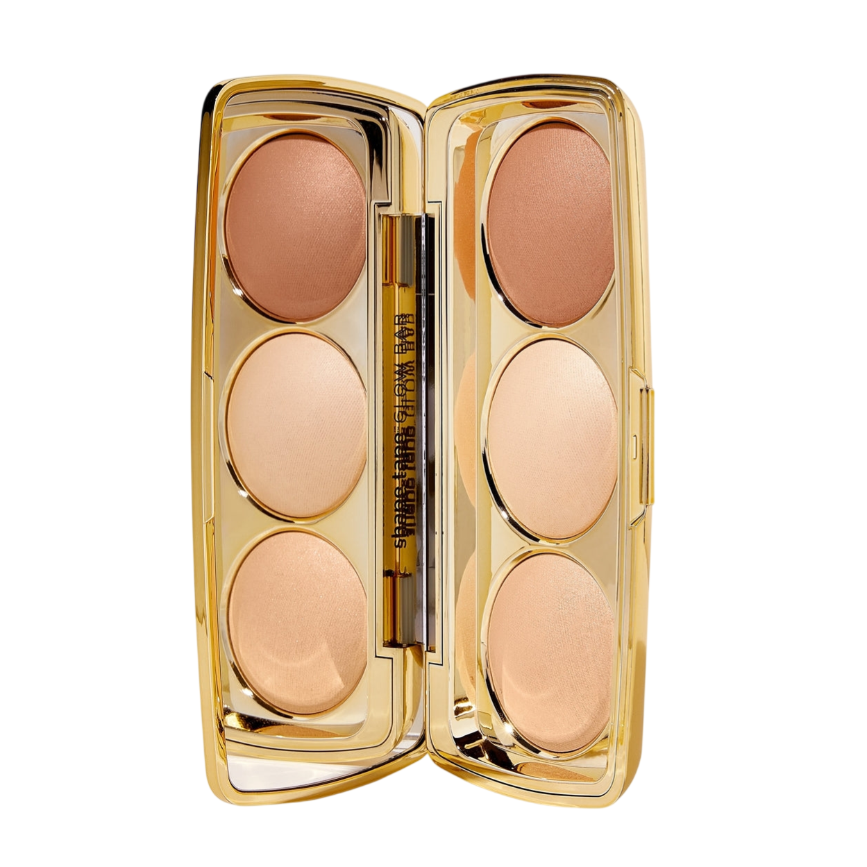 A compact containing six shades of face powders in a gold case with a small brush.
