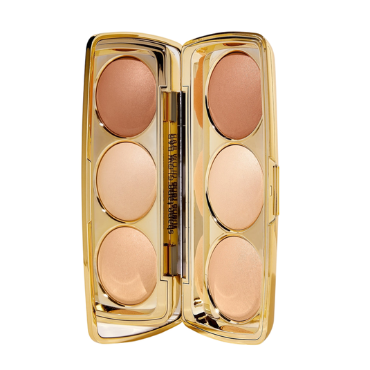 A compact containing six shades of face powders in a gold case with a small brush.