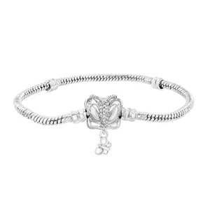 A silver bracelet featuring a butterfly design with a small dangling charm, set on a snake chain.
