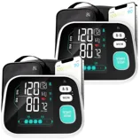 Two digital blood pressure monitors with large displays show readings for systolic and diastolic pressure, pulse rate, and include memory and start/stop buttons.