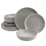 A set of minimalist gray dinnerware including plates and bowls, each a uniform color and design, neatly stacked together.