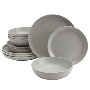 A set of minimalist gray dinnerware including plates and bowls, each a uniform color and design, neatly stacked together.
