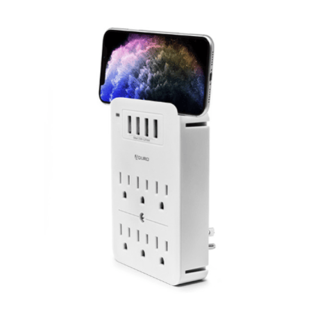 A wall-mounted power strip with multiple outlets and USB ports, featuring a slot holding a smartphone horizontally.
