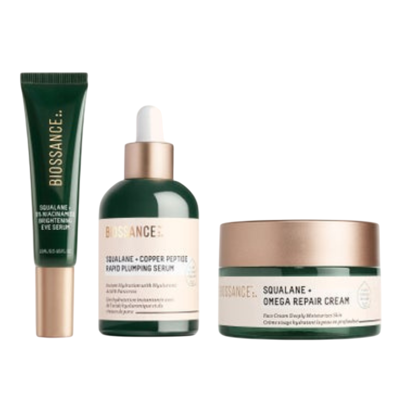 Biossance skincare set featuring Squalane + Vitamin C Rose Oil, Squalane + Copper Peptide Rapid Plumping Serum, and Squalane + Omega Repair Cream.