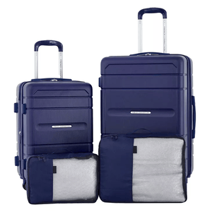 The 4pc French Connection Luggage Set includes two navy blue hardshell suitcases with telescopic handles, accompanied by two packing cubes, one placed in front of each suitcase.