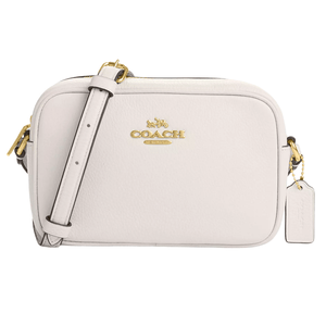 A white Coach crossbody bag featuring gold hardware, a zip closure, and an adjustable strap.
