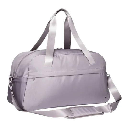 A light purple duffel bag with dual handles and an adjustable shoulder strap, featuring a front pocket and zippered closure.