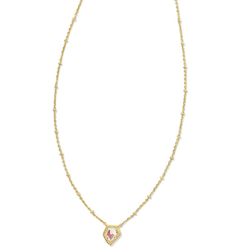 Kendra Scott Tess Satellite Necklace features a delicate gold chain with small beads and a hexagonal pendant with an iridescent pink stone at the center.