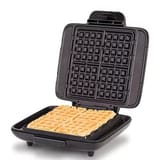 A waffle maker with a square waffle inside, featuring a nonstick grid design.