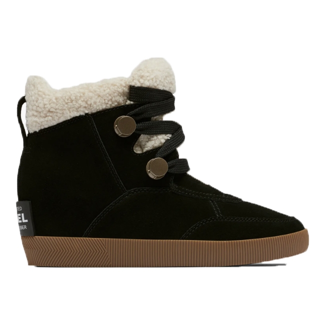 A black suede high-top sneaker with a fluffy white lining and two metallic button-like closures on elastic straps.