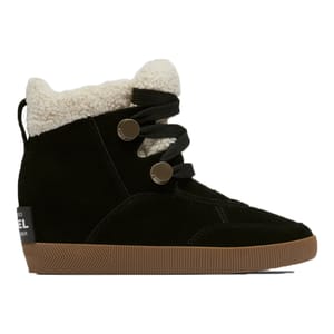 A black suede high-top sneaker with a fluffy white lining and two metallic button-like closures on elastic straps.