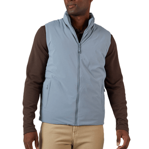 A man is wearing a light blue zip-up vest over a brown long-sleeve shirt and beige pants.