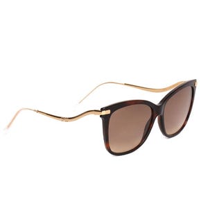 Cat-eye sunglasses with tortoiseshell frames and gold-toned temples featuring brown gradient lenses.