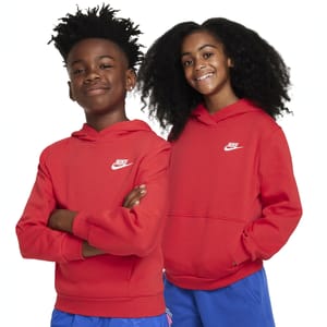 Two children wearing red Nike hoodies with the Nike logo on the chest. The hoodies are paired with blue pants.
