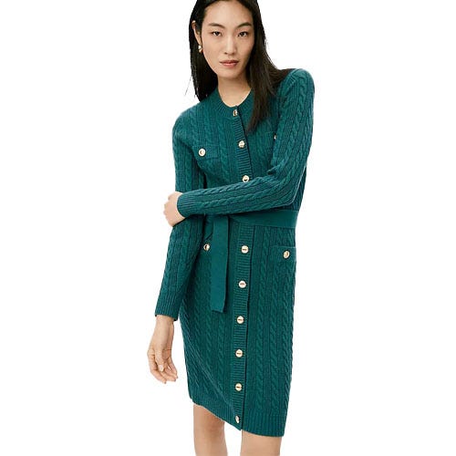 A woman models a teal cable-knit cardigan dress with gold button accents and a waist tie.