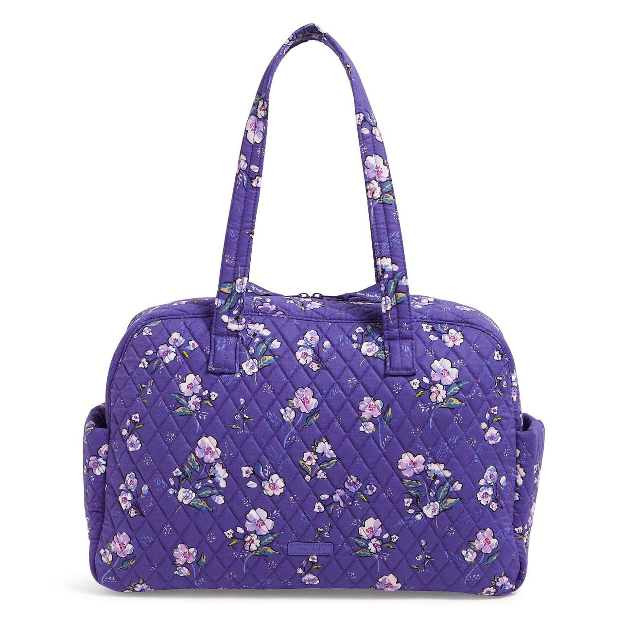 Purple quilted traveler bag with floral pattern, featuring two shoulder straps and side pockets for convenient storage.
