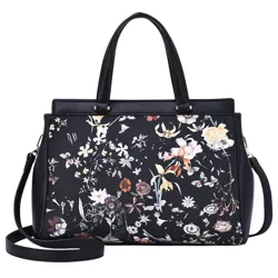 A black handbag featuring a floral pattern with a detachable shoulder strap and top handles.