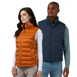 Two people wearing quilted vests; the woman wears an orange vest with a white long-sleeve top, and the man wears a navy vest with a green long-sleeve top and jeans.