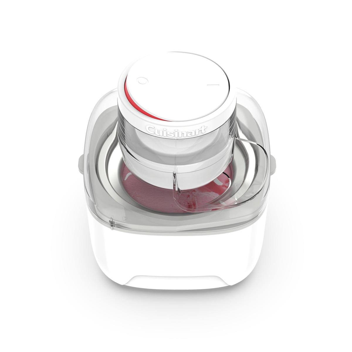 A Cuisinart ice cream maker with a clear lid is shown. The machine is white with a round top and has red-colored ice cream in the processing bowl.