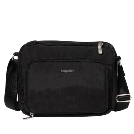 A black crossbody bag with silver zippers and the \“Baggallini\“ logo on the front. It features an adjustable shoulder strap and a front zip pocket.