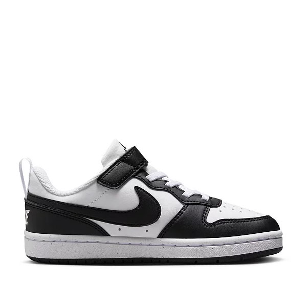 A white and black low-top sneaker with Velcro strap and laces, featuring a prominent black Nike swoosh logo on the side.