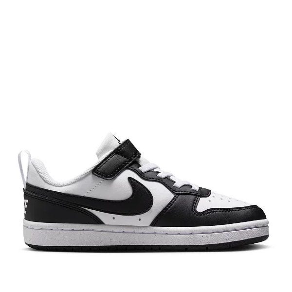 A white and black low-top sneaker with Velcro strap and laces, featuring a prominent black Nike swoosh logo on the side.