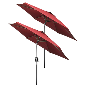 Two red patio umbrellas with a crank handle are shown, featuring tiltable canopies supported by black metal poles.