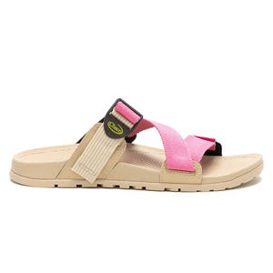 Chaco Lowdown Slides feature a tan sole with a pink and tan adjustable strap equipped with a buckle for secure fit. The footbed is contoured for comfort and the outsole is lightly treaded for traction.