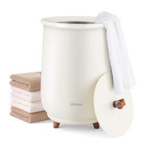 A COSTWAY brand towel warmer, cylindrical in shape with a wooden knob on the side and small legs, alongside a pile of folded towels. A white towel is draped over it.