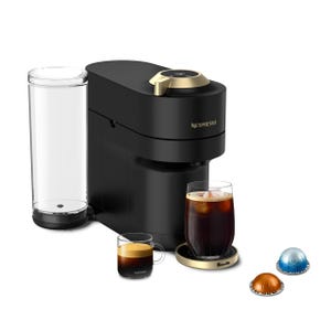Nespresso coffee machine with a sleek black design, featuring two coffee cups and three coffee pods in different colors, alongside a transparent water tank.