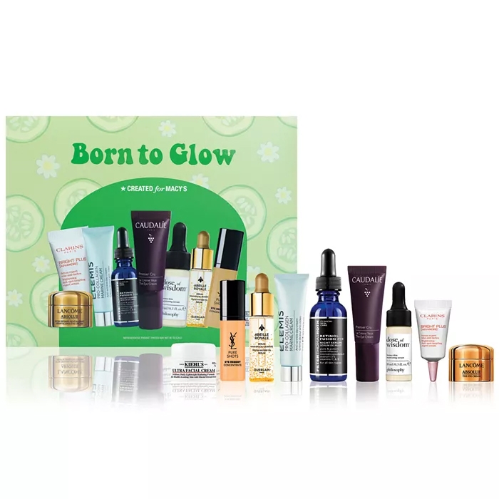 The 9pc Born To Glow Skincare Set includes a variety of travel-size skincare products such as moisturizers, serums, and creams from brands like Lancôme, Kiehl's, Clarins, and Caudalie. Designed to enhance and illuminate the skin, packaged for Macy's.