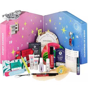 An advent calendar from Sephora is shown, containing various beauty items such as makeup, skincare products, and beauty tools.