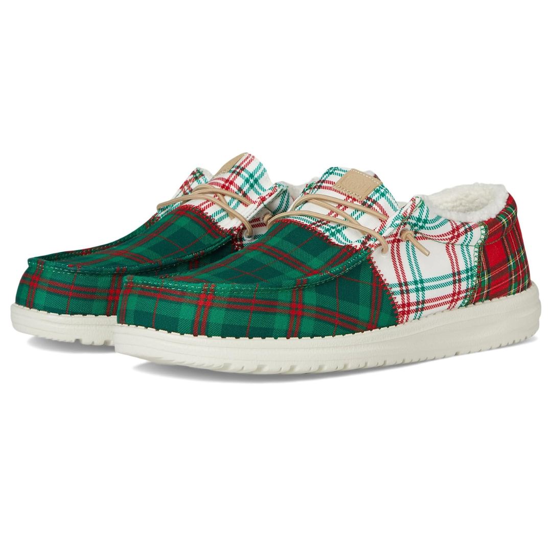Hey Dude Men's shoes feature a festive plaid design in green, red, and white, with a cozy lining and white soles.