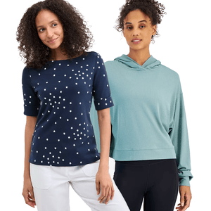 Two women standing side by side, one wearing a navy top with white star patterns and white pants, the other in a light teal hooded pullover with black leggings.
