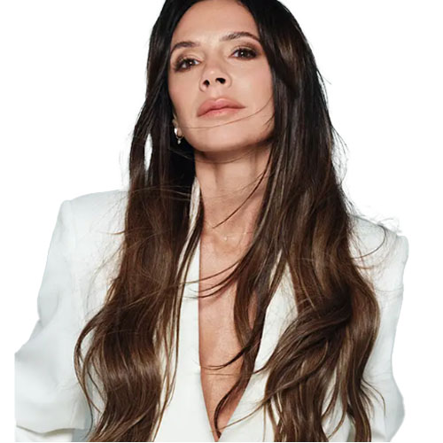 A woman with long, brown hair and wearing a white blazer, set against a plain background.