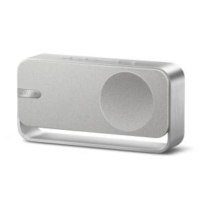 A sleek, portable Bluetooth speaker with a metallic frame and fabric-covered front. It features a handle for easy carrying and control buttons on top.