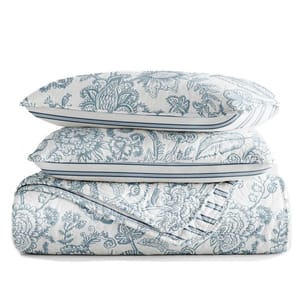 King Reversible Quilt Set features a floral pattern in blue on a white background, including a quilt and two shams. The design is intricate and provides a classic, elegant look for bedding.
