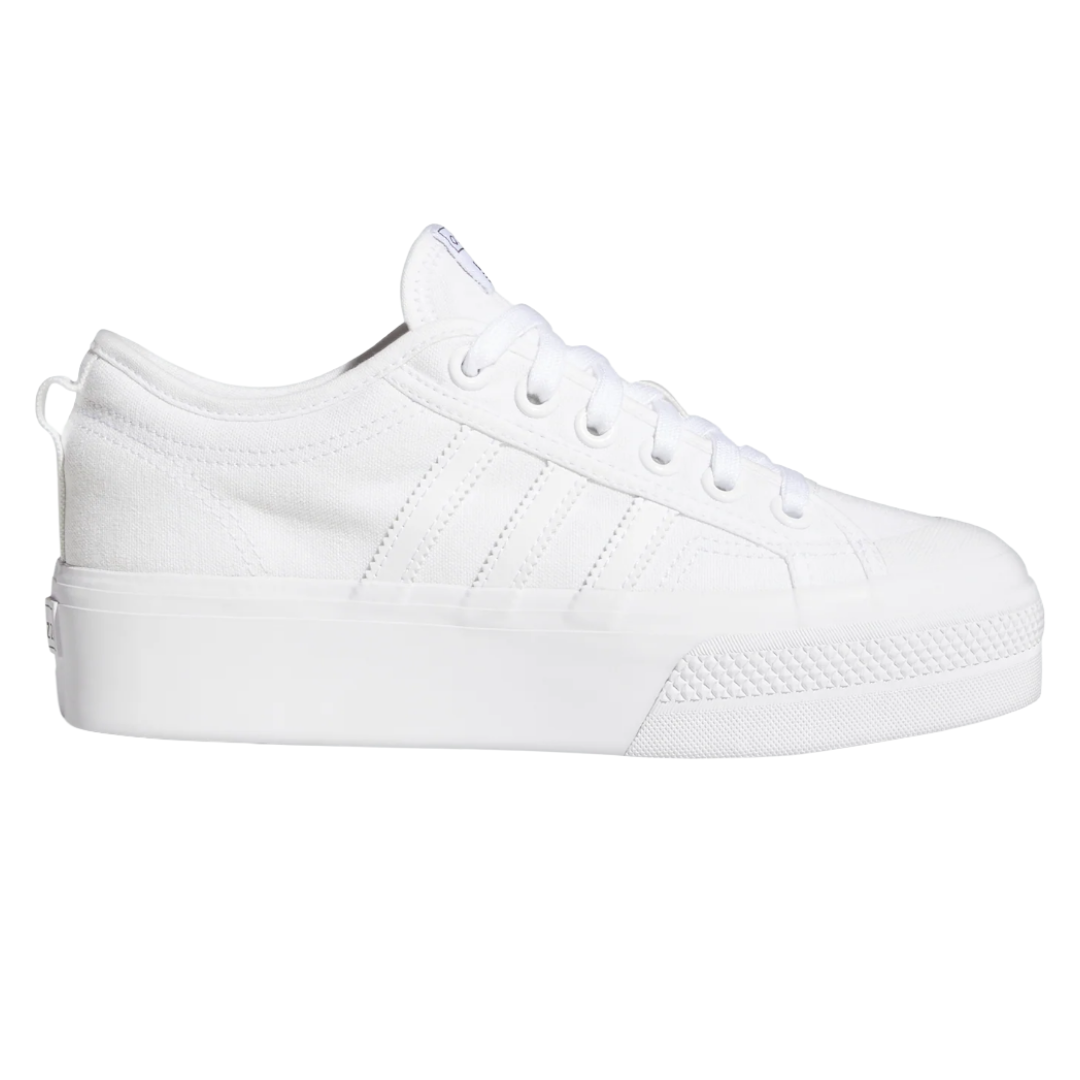 White low-top sneaker with a thick platform sole, featuring subtle stitching and a minimalist design.