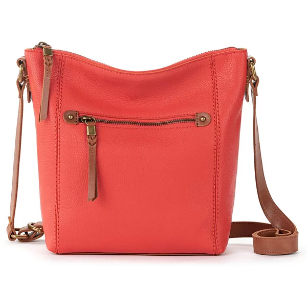 Coral leather crossbody bag with a front zipper pocket and brown adjustable strap.