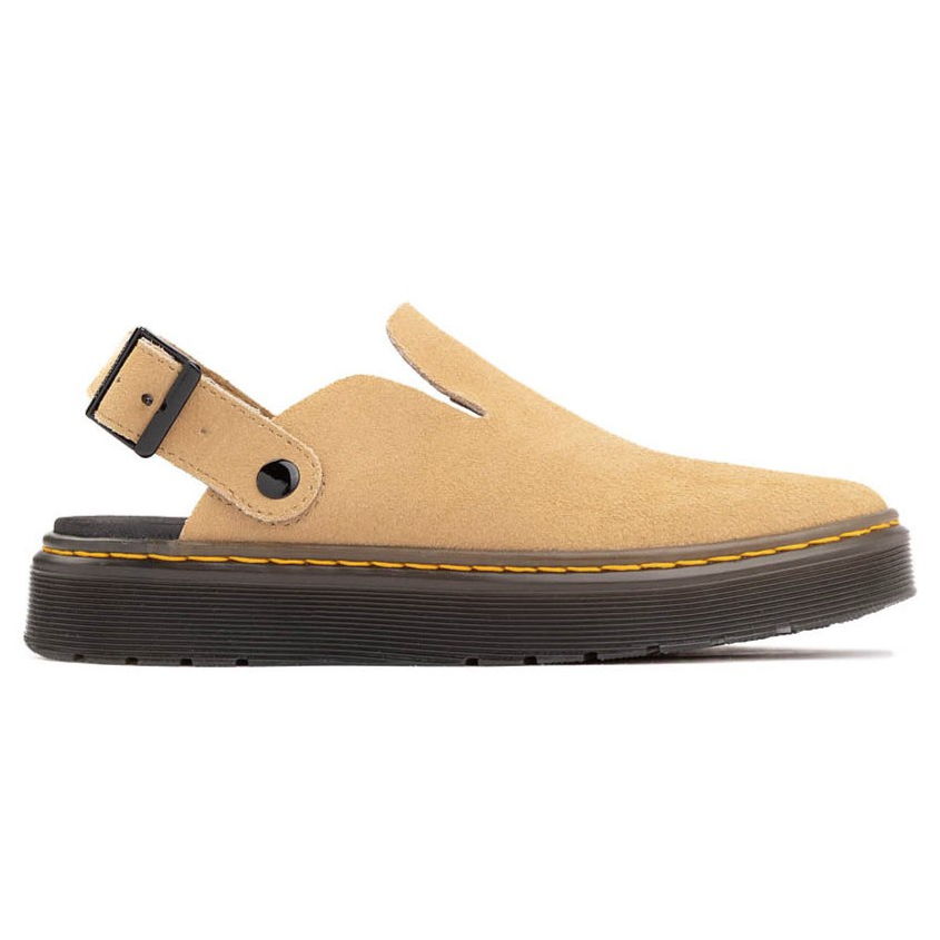 Tan suede slip-on shoe with a black platform sole and yellow stitching, featuring an adjustable heel strap with a buckle.