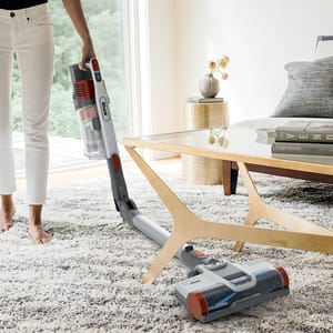 The Shark Pet Pro Multiflex Stick Vacuum features a flexible design for cleaning under furniture, a handheld mode for versatility, and strong suction for pet hair. It includes a detachable dustbin and an articulated wand for easy maneuverability.