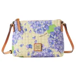 A crossbody bag with a floral design featuring purple hydrangeas, leather straps, and a Dooney & Bourke logo patch.