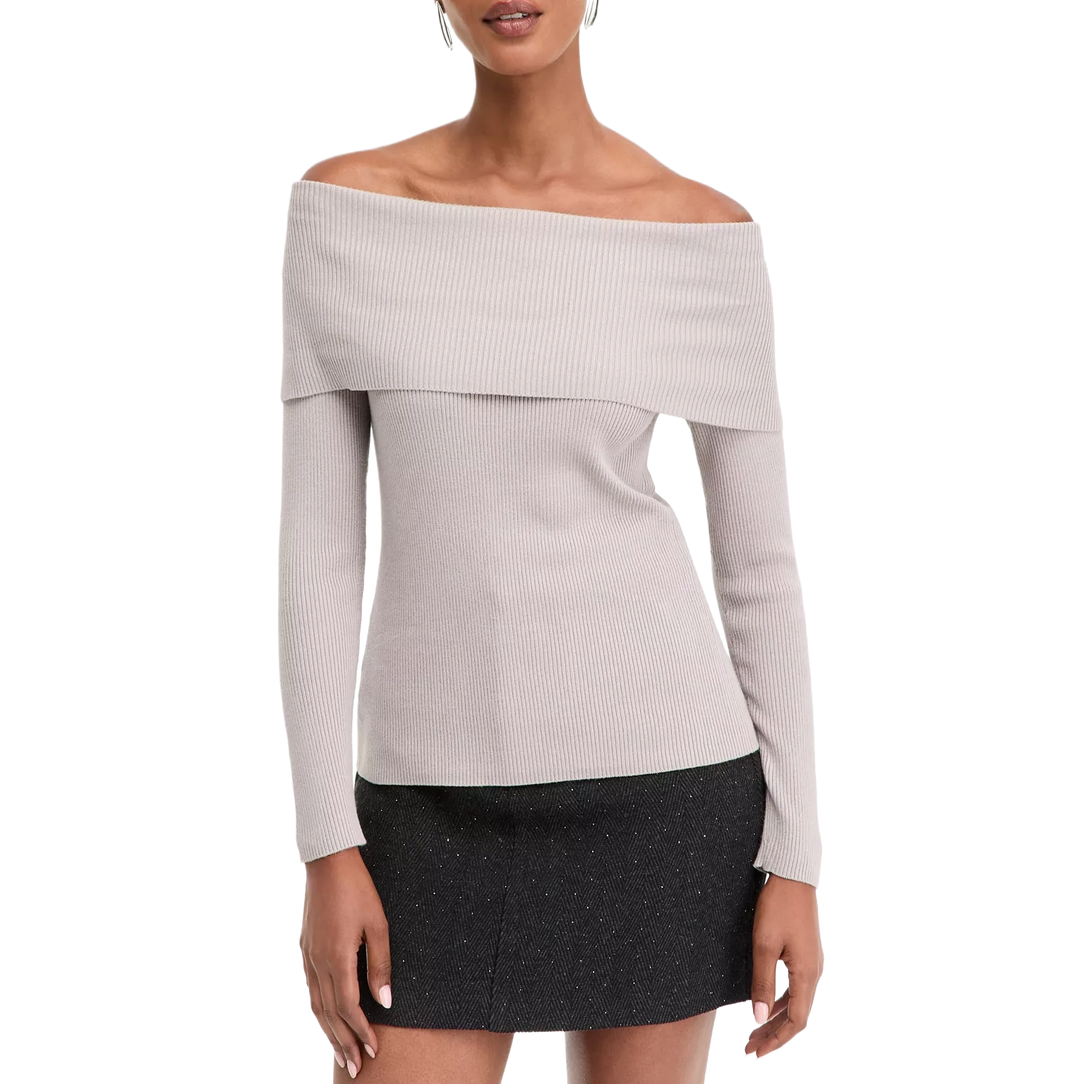 Off-the-shoulder beige ribbed knit top paired with a short black skirt.