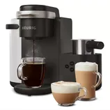 The Keurig K-Cafe is a black coffee and latte maker, featuring a milk frother and controls for brewing coffee, lattes, and cappuccinos. Three glass mugs show brewed coffee and frothy drinks in front of the machine.