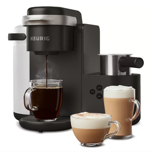 The Keurig K-Cafe is a black coffee and latte maker, featuring a milk frother and controls for brewing coffee, lattes, and cappuccinos. Three glass mugs show brewed coffee and frothy drinks in front of the machine.